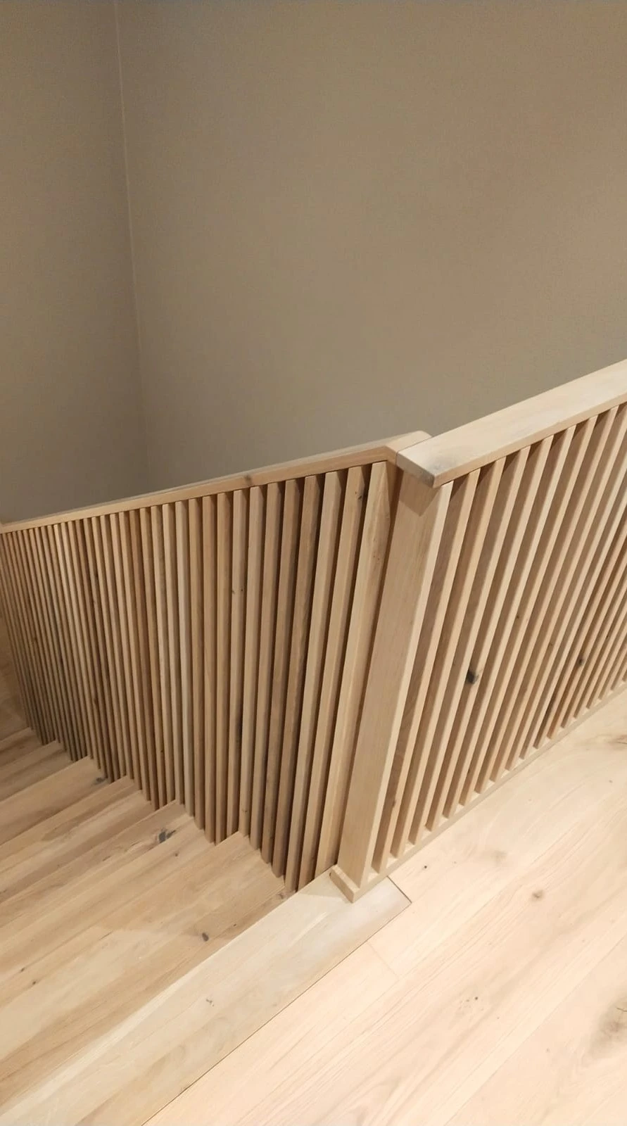Betontreppe in Faltwerkoptik mit Wildeiche-Stufen und filigranem Holzstabgeländer 2