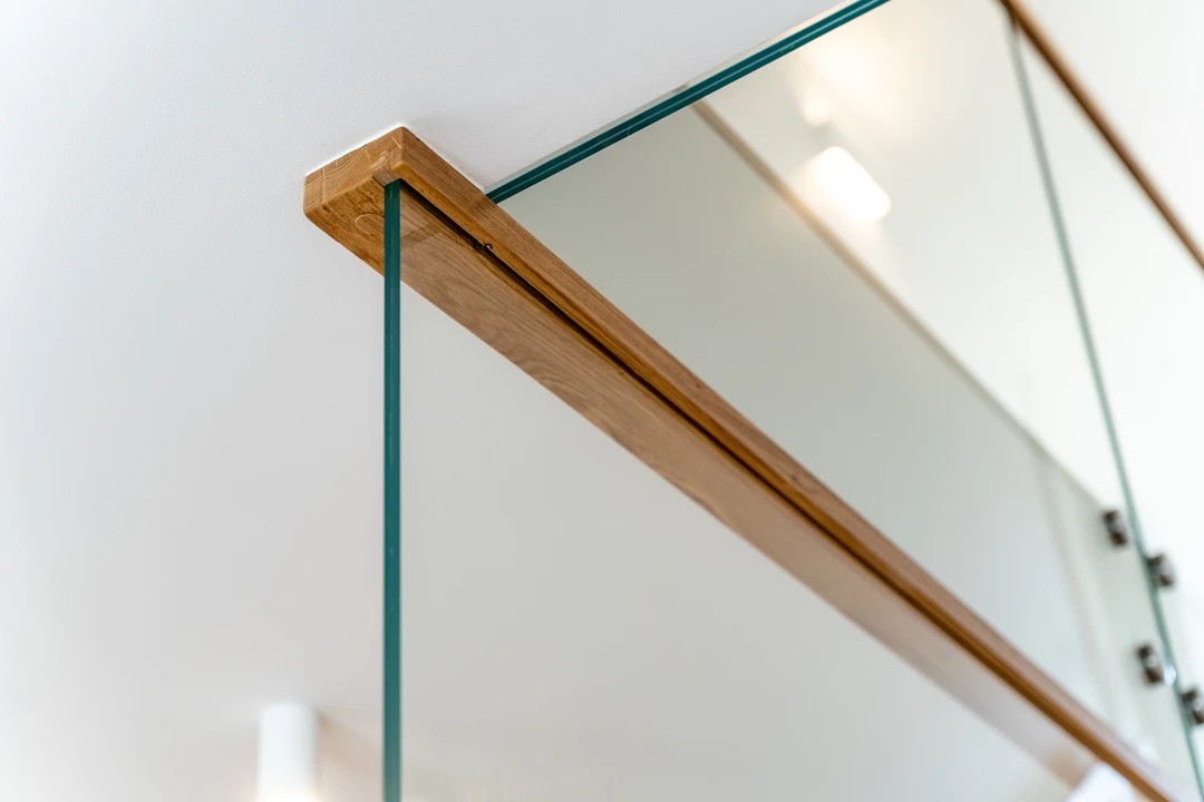 Moderne Stufen auf Beton (Treppe in Faltwerkoptik) mit eingelassenem Glasgeländer, Holzhandlauf und Holzstufen  10